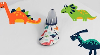 A kids' water shoe with a dinosaur design, surrounded by cartoon dinosaurs.