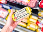hand holding a roll of jimmy dean sausage in walmart aisle