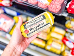 hand holding a roll of jimmy dean sausage in walmart aisle