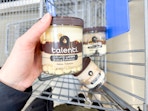 hand holding a Talenti Gelato pint in front of two pints in the cart