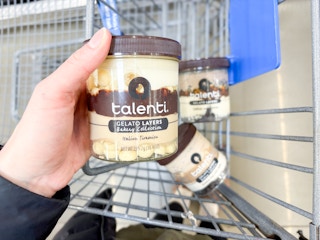 hand holding a Talenti Gelato pint in front of two pints in the cart