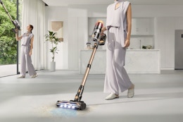 woman using cordless vacuum on floor