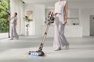 woman using cordless vacuum on floor