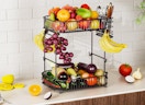 a fruit basket on a kitchen counter with fruit inside
