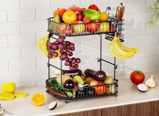 a fruit basket on a kitchen counter with fruit inside