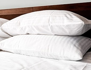 A set of Beckham Hotel Collection pillows on a bed.