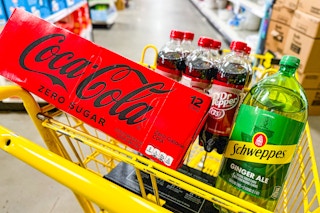 coke, dr pepper and schweppes in a yellow shopping cart