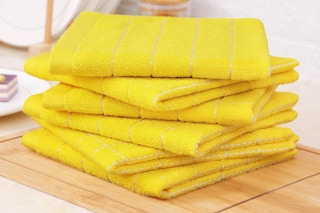 a stack of yellow dishcloths