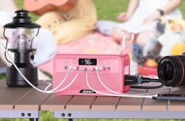 devices and a lamp plugged into a pink power station 