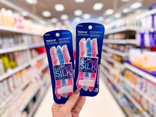 hand holding two package of Schick Hydro Silk Razors