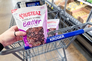 hand holding krusteaz batter with kroger shopping cart