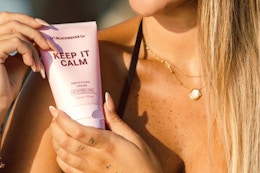 a woman holding beachwaver smoothing cream