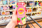 hand holding a can of lipton fusions tea