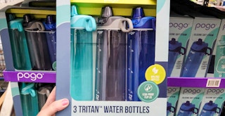 a person holding up a three pack of pogo water bottles