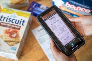 A person taking a photo of a Target receipt, submitting it on the Checkout51 app.