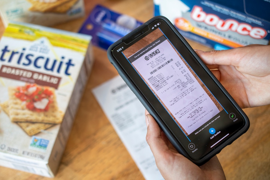 A person taking a photo of a Target receipt, submitting it on the Checkout51 app.