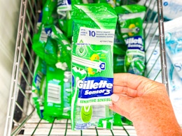 person grabbing a gillette sensor 3 razor out of a basket