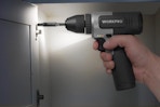 Person holding and using the WORKPRO 8V Cordless Drill Set in a cabinet.