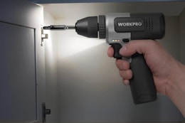 Person holding and using the WORKPRO 8V Cordless Drill Set in a cabinet.