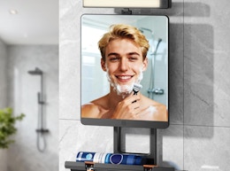 a person shaving is a mirror with a light