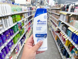 hand holding head & shoulders shampoo in walgreens