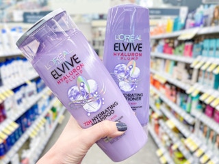 hand holding two bottle of l'oreal elvive