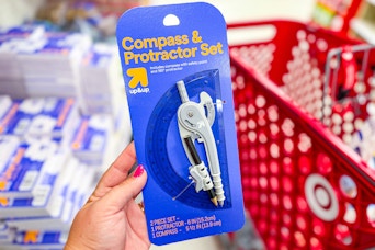 hand holding an up & up compass & protractor set at target