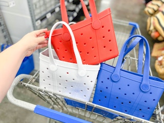 hand touching a red time and tru mini tote with two in walmart cart