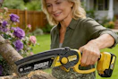 a woman using a chainsaw