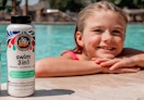 a kid at the pool next to a shampoo bottle