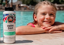 a kid at the pool next to a shampoo bottle