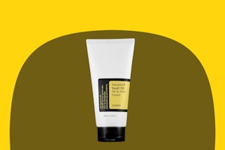 a hand holding a box of serum in a store