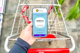 hand holding a smartphone displaying a kcl coupon barcode