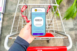 hand holding a smartphone displaying a kcl coupon barcode