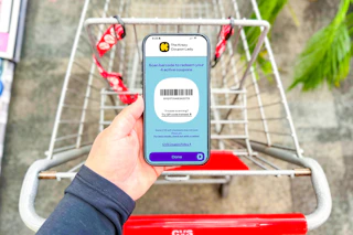 hand holding a smartphone displaying a kcl coupon barcode