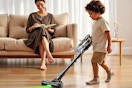a boy vacuuming the floor