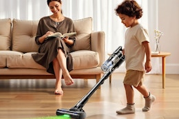 a boy vacuuming the floor