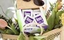 a box of individually wrapped lens cloths in a basket of flowers