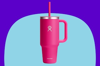 Hydro Flask Travel Tumbler with Handle on a blue background.