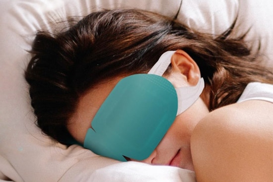 a woman using an eye steam mask