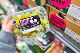 hand holding cotton candy grapes at aldi
