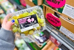 hand holding cotton candy grapes at aldi