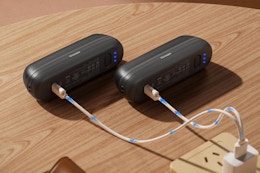 OCOOPA 2 in 1 Magnetic Rechargeable Hand Warmers on a table charging.