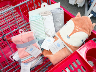 cloud island towels and washcloths sitting in a target cart