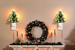  Lakumu 2-Pack 6’’ Christmas Tree Night Lights, Resin Decorative Christmas Night Light plugged in on a wall.