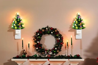 Lakumu 2-Pack 6’’ Christmas Tree Night Lights, Resin Decorative Christmas Night Light plugged in on a wall.