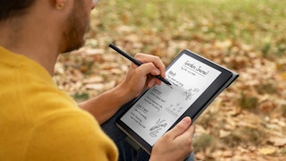 man writing on Kindle Scribe