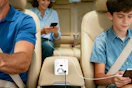 family using inverter to power devices in car