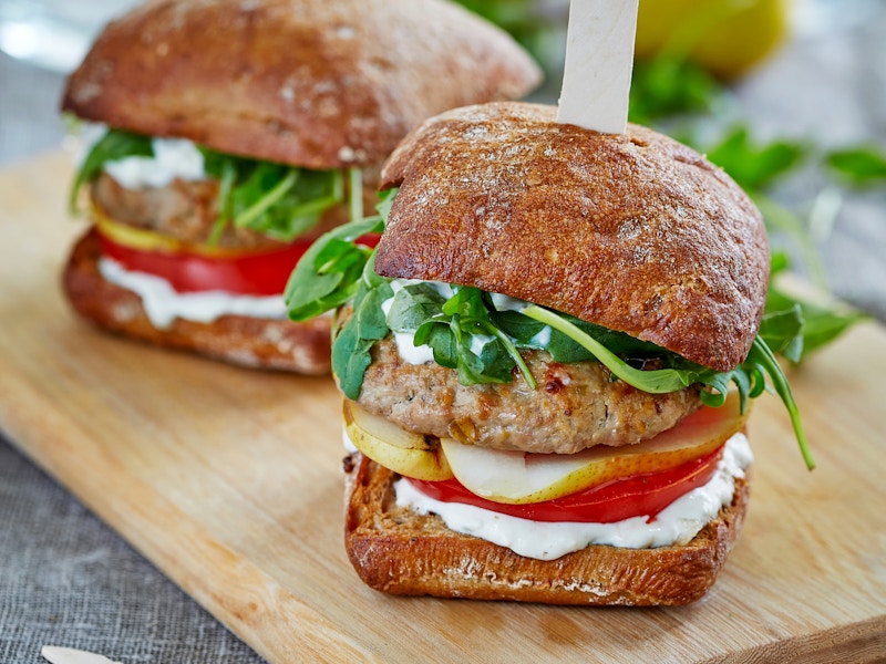 A pair of sliders on a wooden cutting board