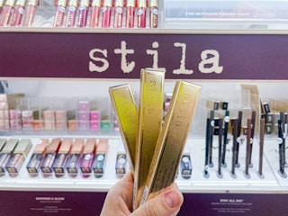 Three Still Stay All Day Smudge Stick Waterproof Eye Liner boxes held out in front of a Still display.